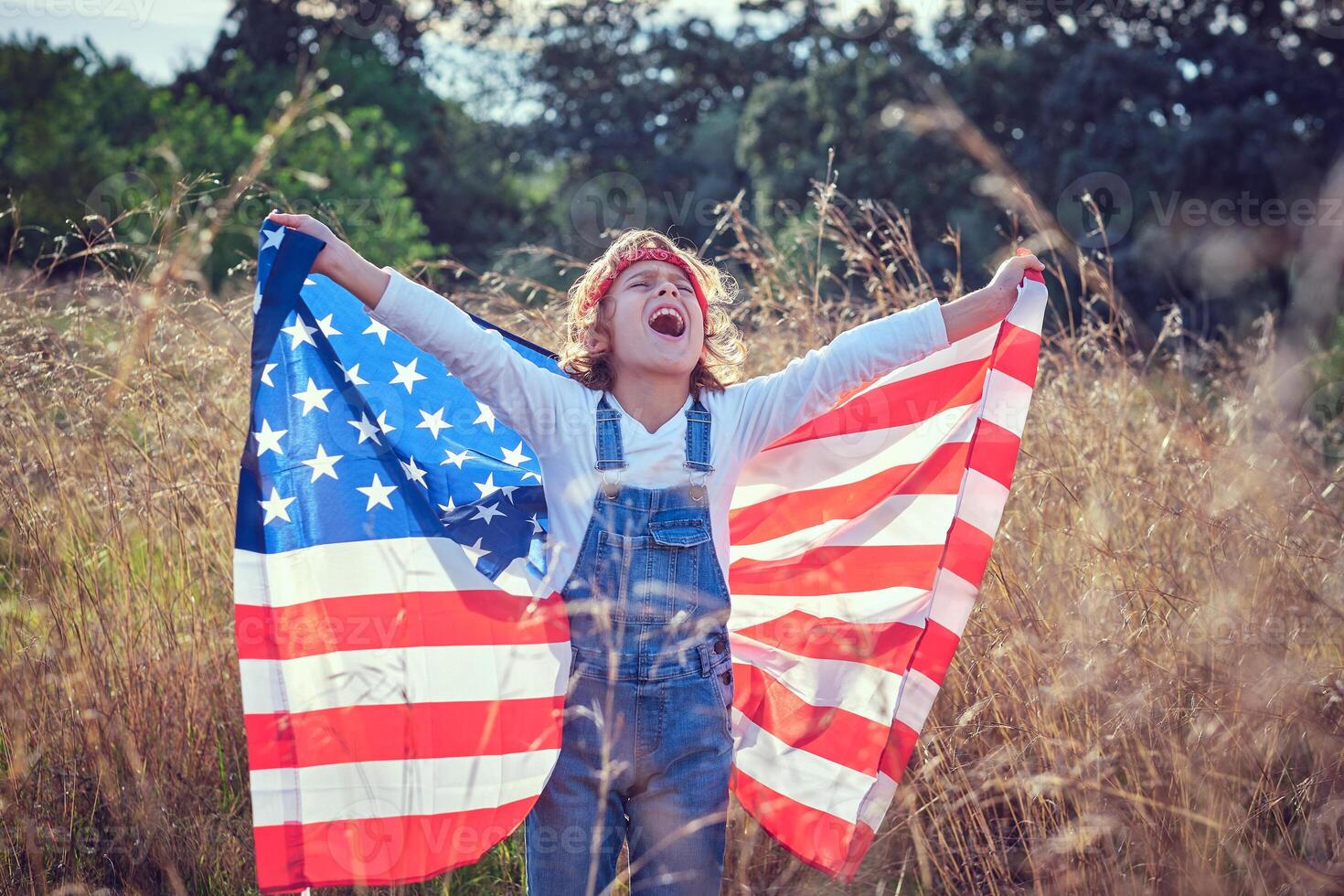 Excited child with USA flag in nature photo