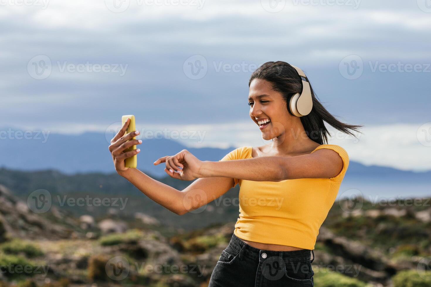 Smiling ethnic woman taking selfie photo