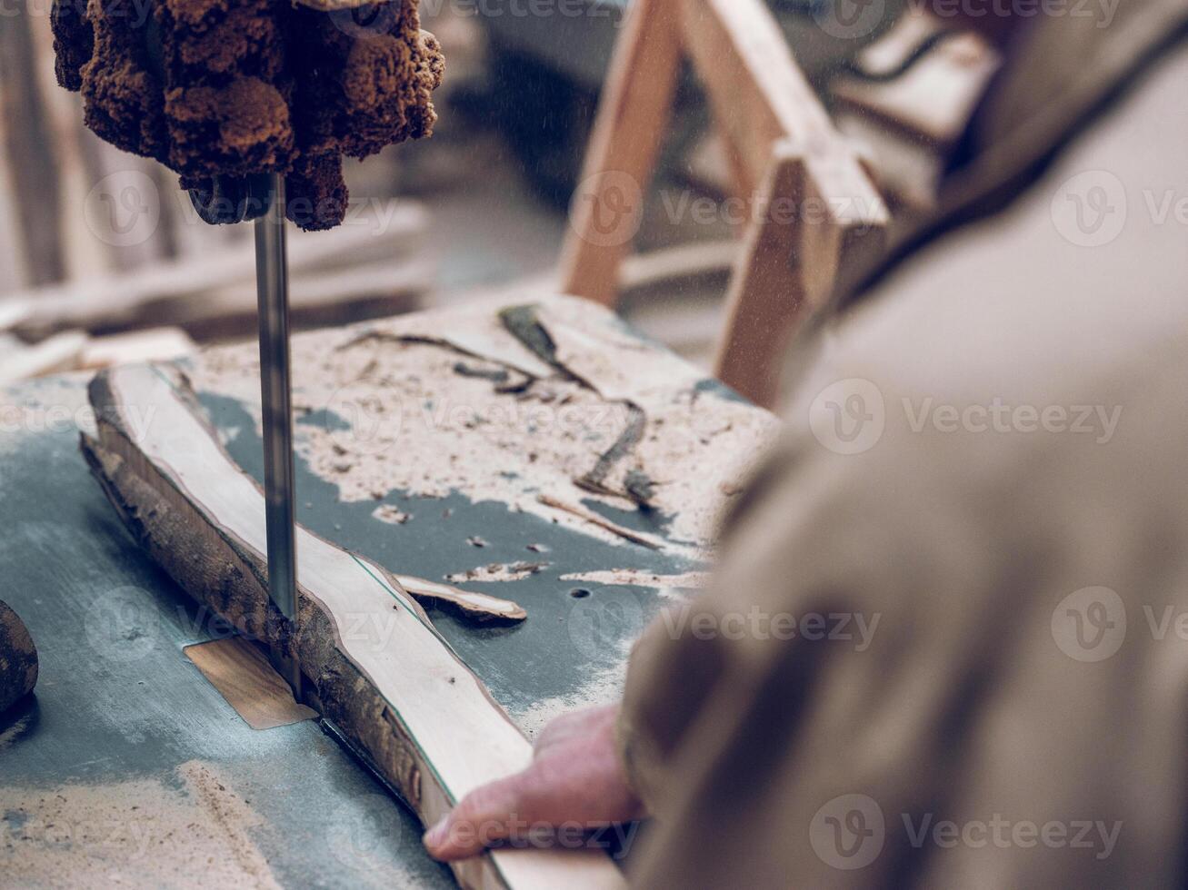Anonymous craftsman cutting wooden board photo