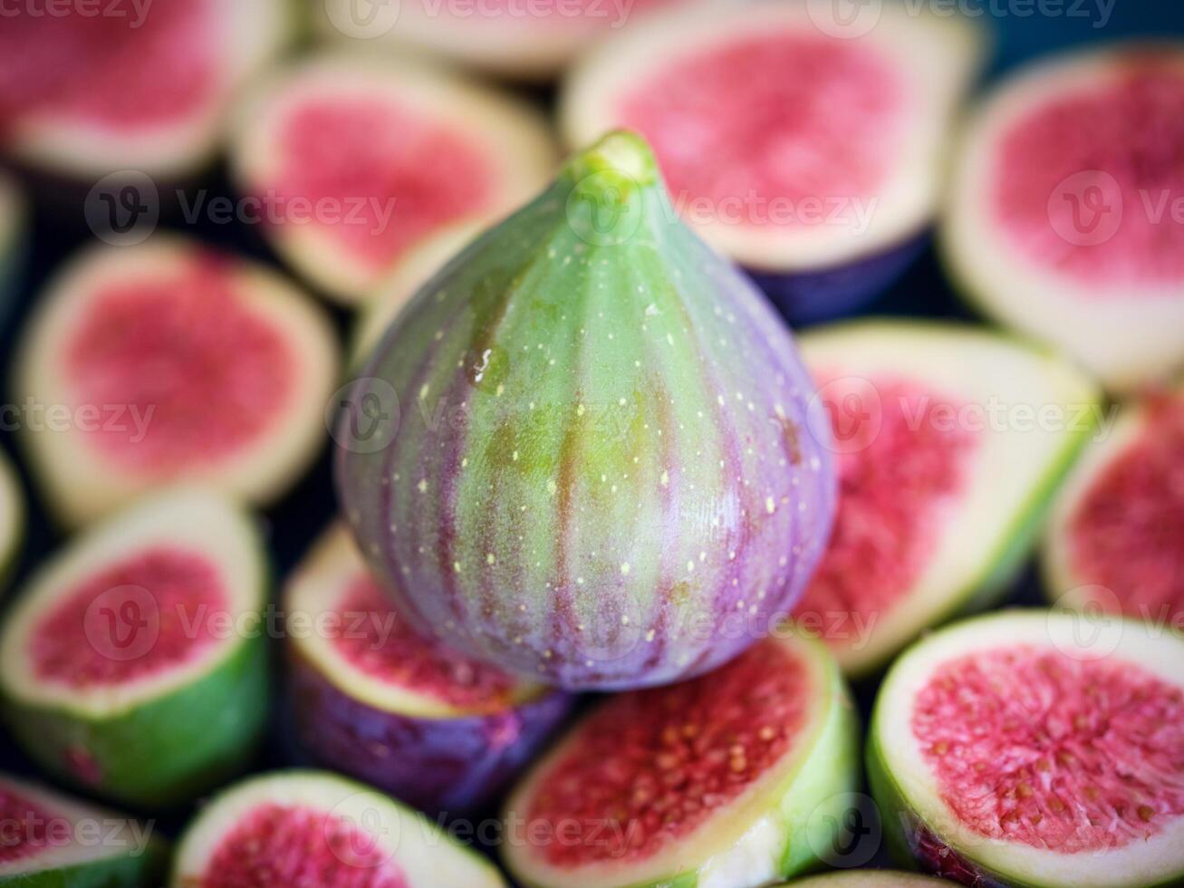 Whole fig placed on halved ones photo