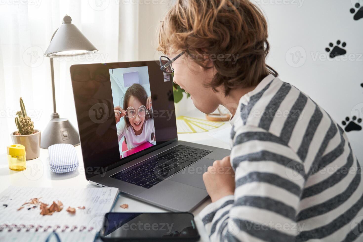 Delighted boy and girl in sunglasses making chat photo