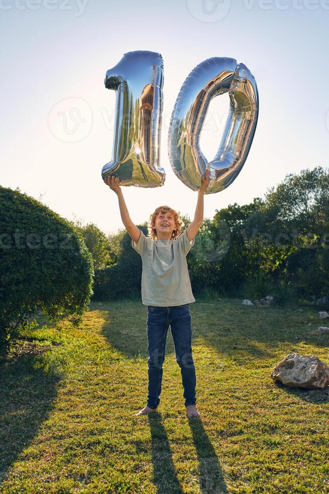 Happy boy with balloon number 10 photo
