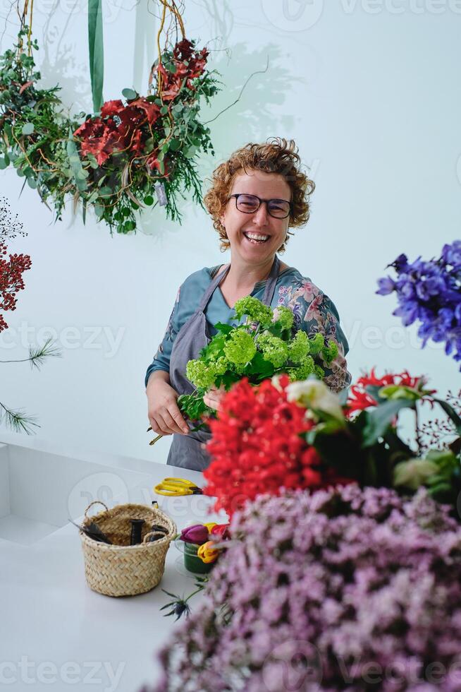 Laughing woman with bouquet of trachelium flowers photo