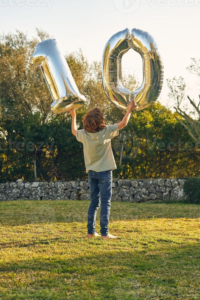 Anonymous boy with number ten made out of balloons photo