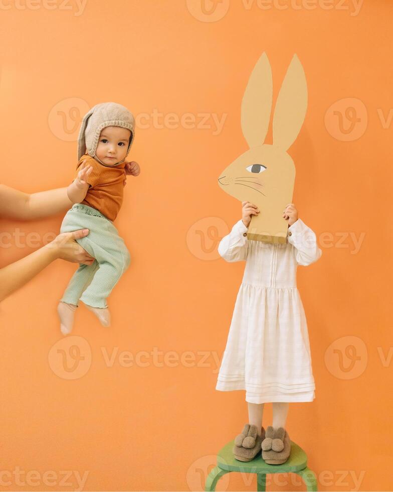 Cute girls with paper rabbit photo