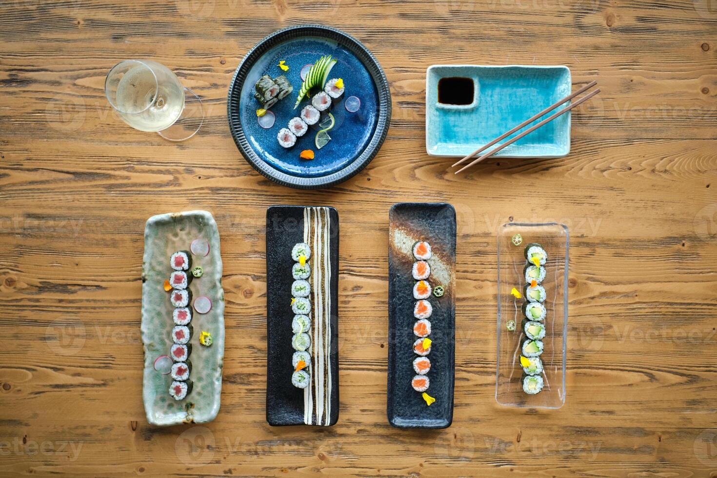 Set of various sushi rolls on wooden table photo