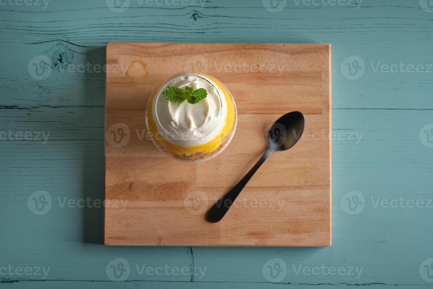 Delicious cheesecake in glass on table photo