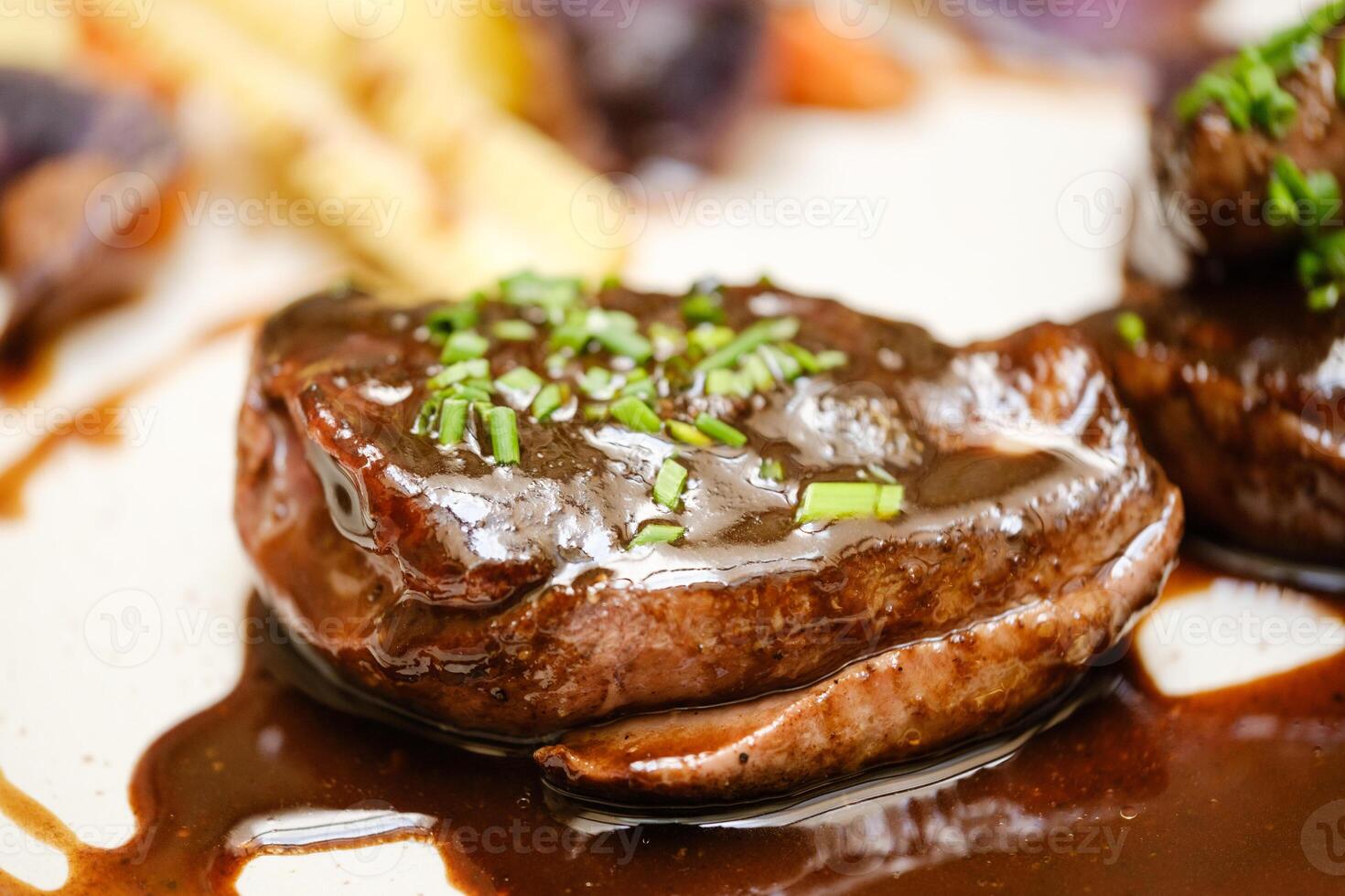 Delicious dish of fried beef steaks with sauce photo