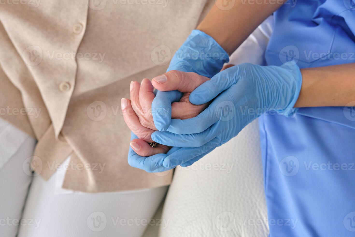 Crop doctor holding patient by hand during checkup photo