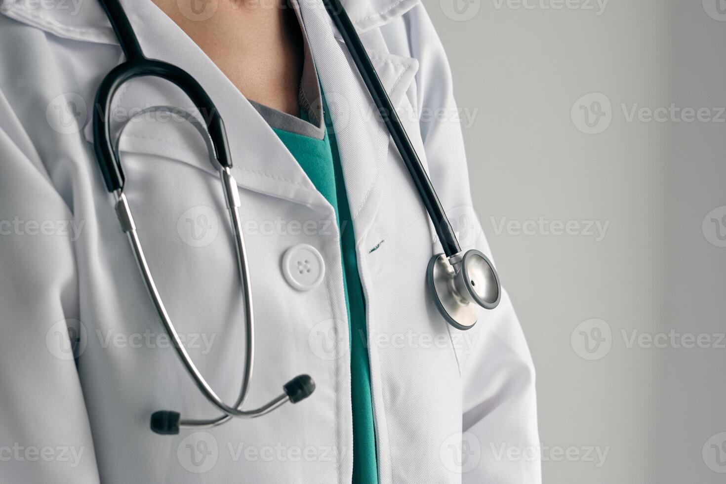 Faceless physician in medical robe with stethoscope photo