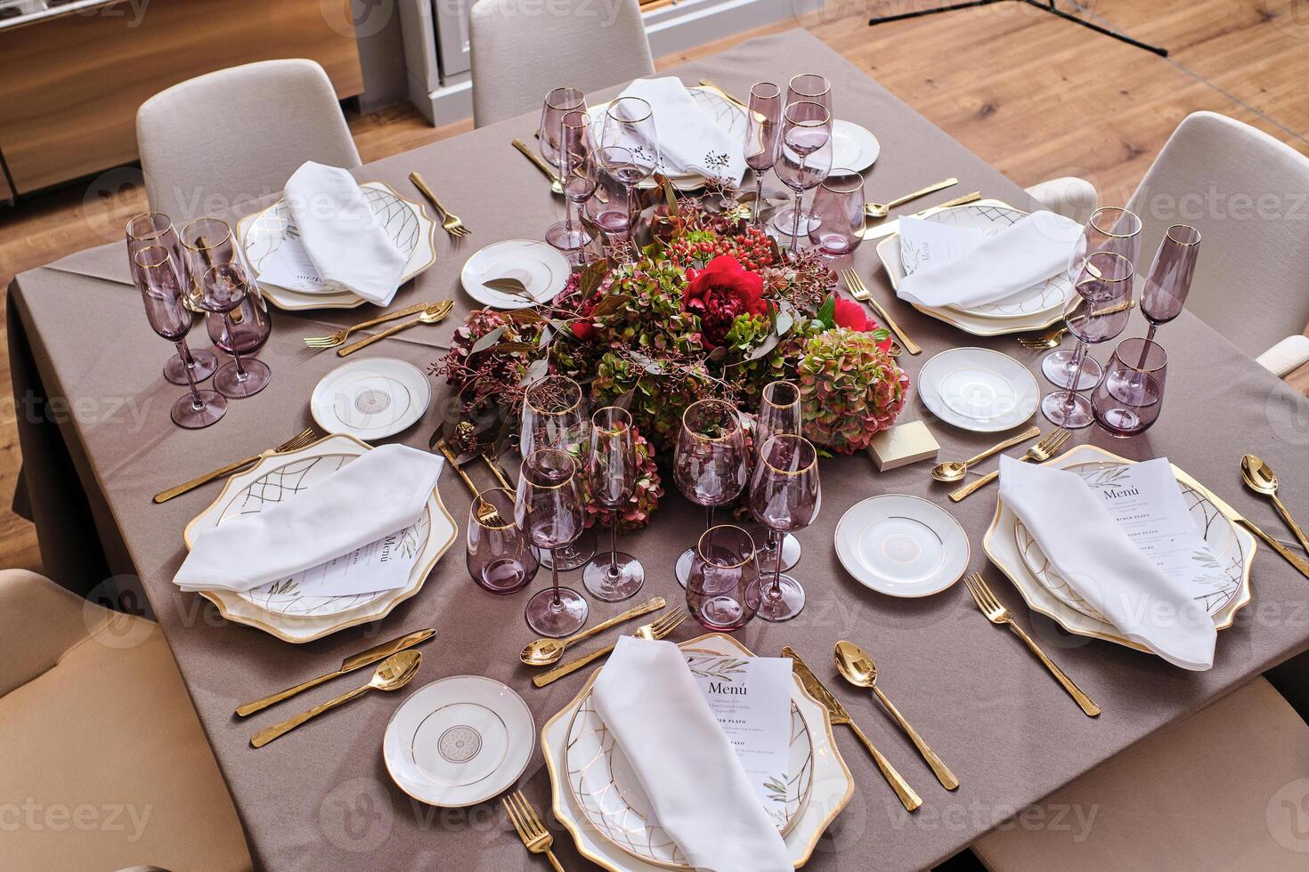 Banquet table with plates and glassware photo
