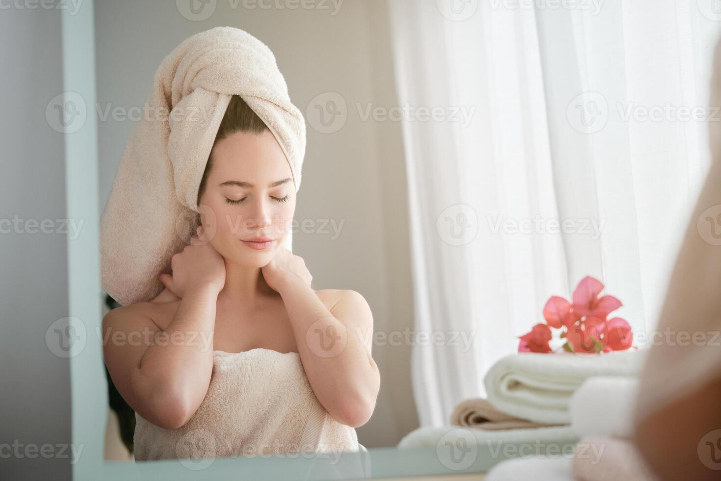 Beautiful woman with eyes closed sitting in front of mirror photo
