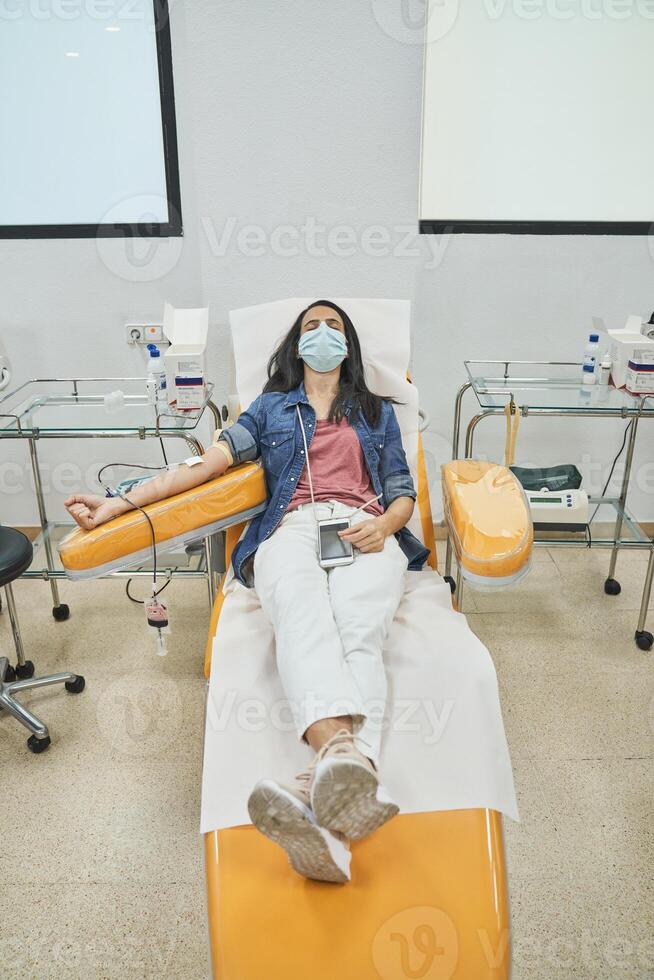 Female patient donating blood from vein photo