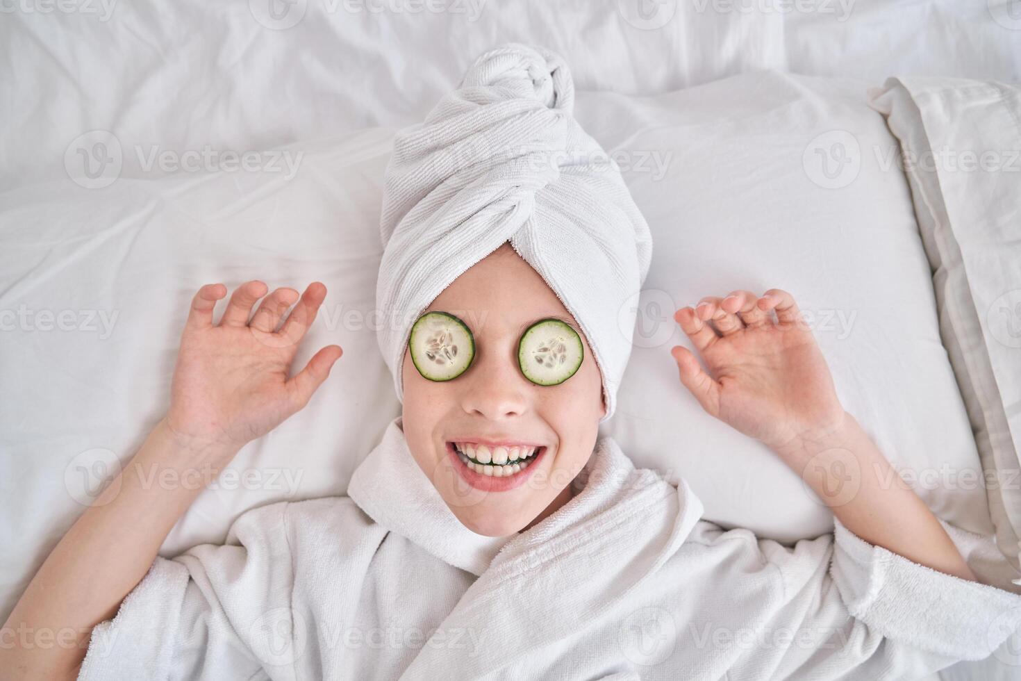 Playful child enjoying spa procedures at home photo