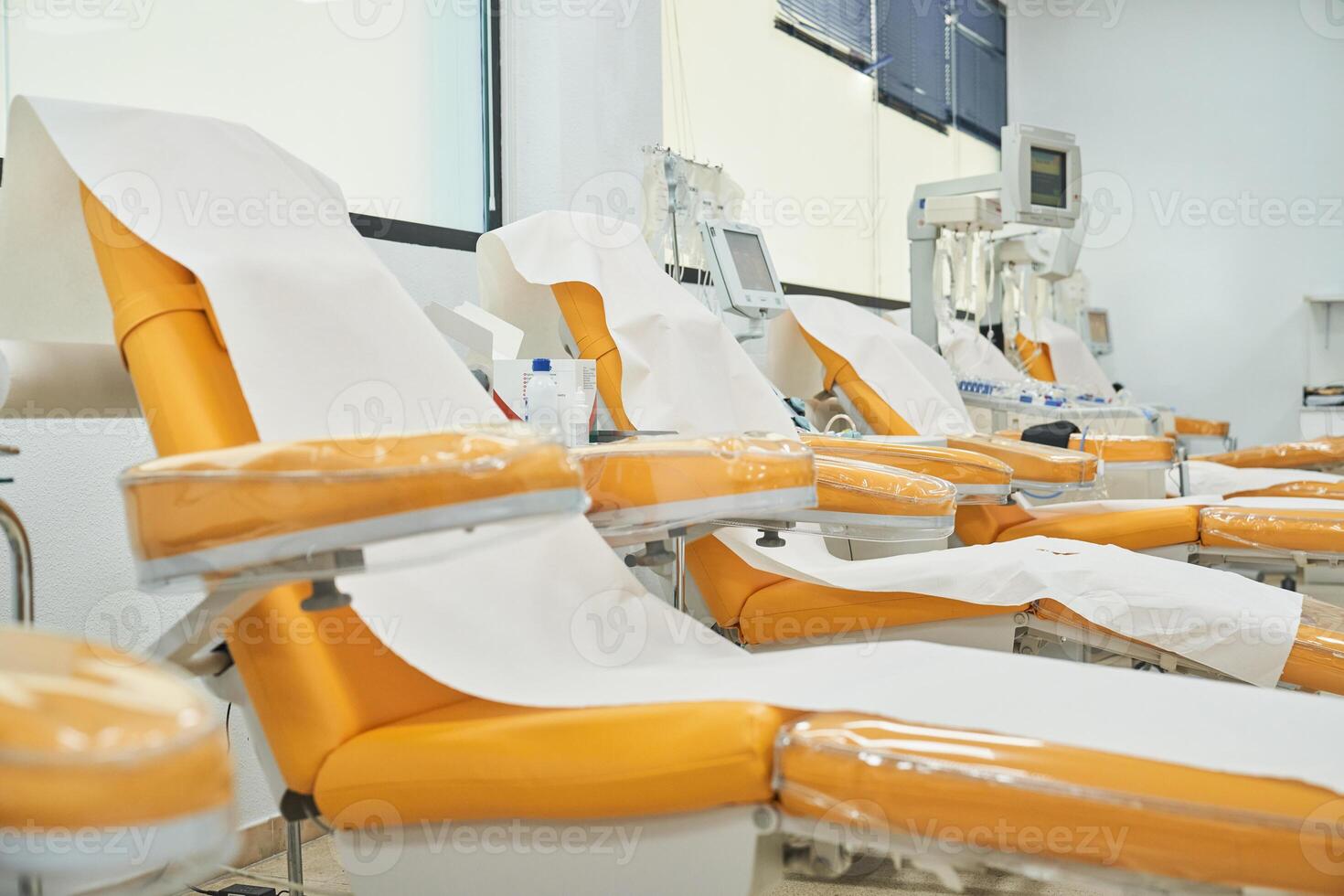 Orange armchairs for sitting in donation center photo