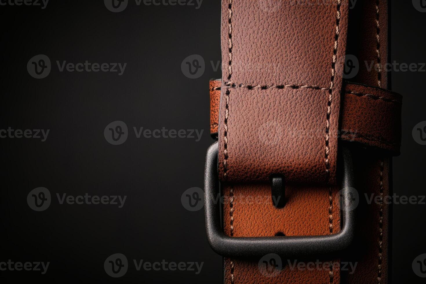 Brown leather belt with metallic buckle detail photo