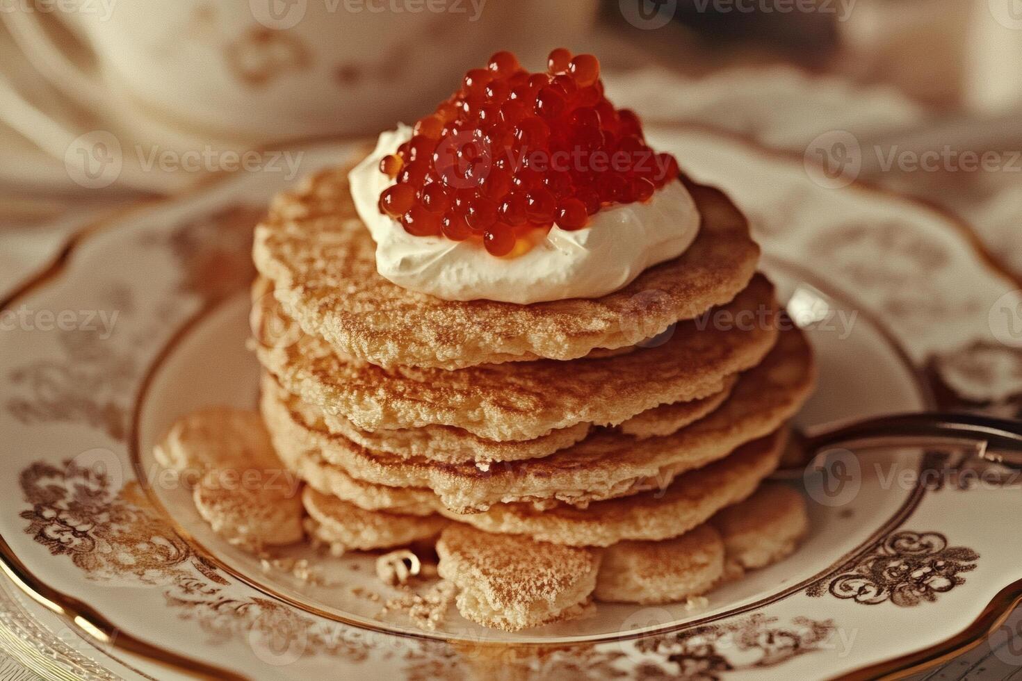 Delicious stack of pancakes topped with cream and caviar presented on an elegant plate in a cozy setting photo