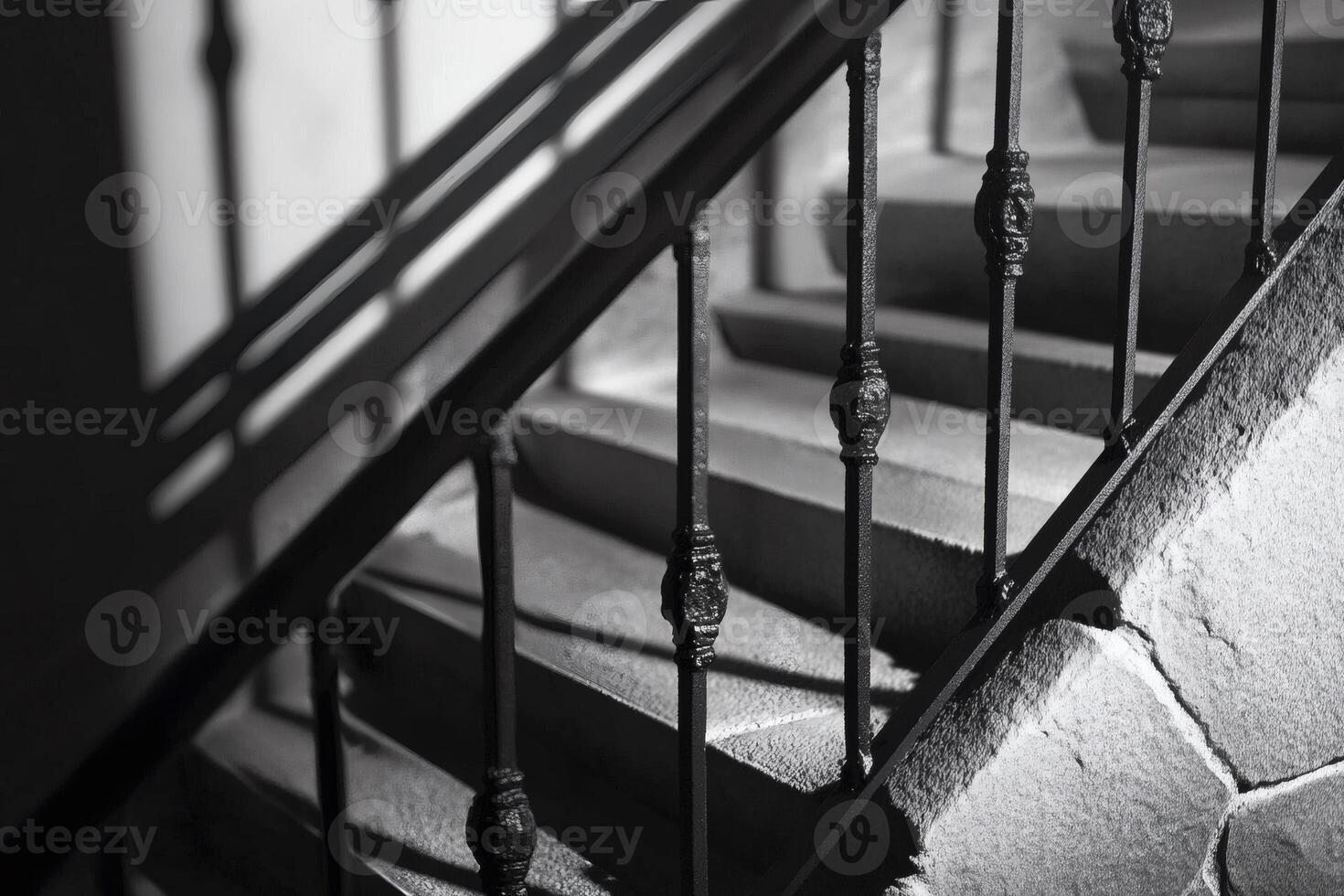 Elegant staircase with wrought iron railing illuminated by soft light in a historic building photo