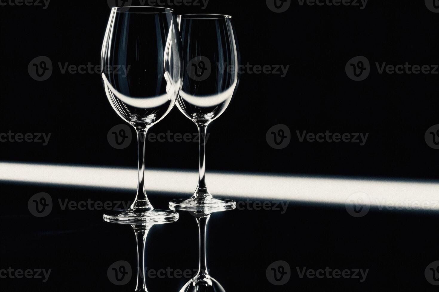 Elegant wine glasses reflecting in soft light. photo