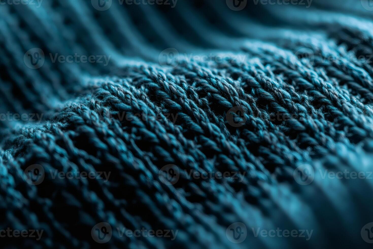 Textured waves of deep blue fabric in soft light. photo