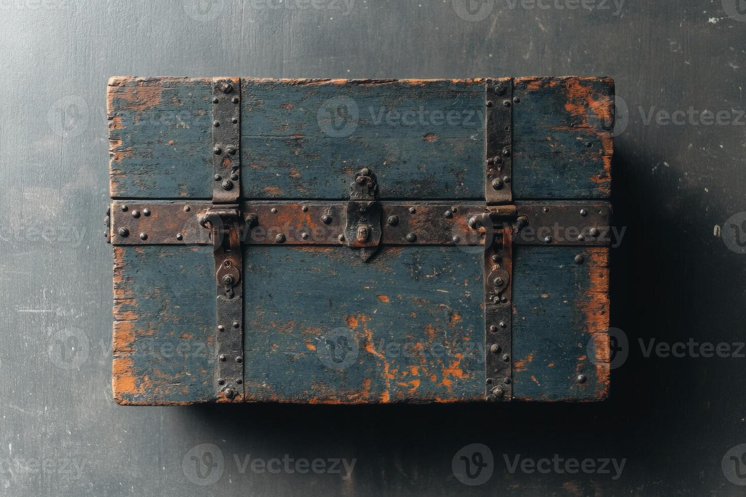 Weathered treasure chest resting on a dark surface. photo