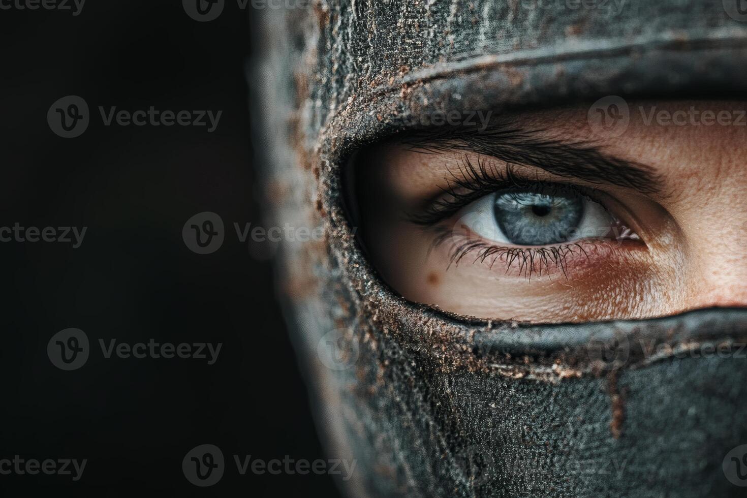 Intense gaze of the masked warrior at twilight. photo