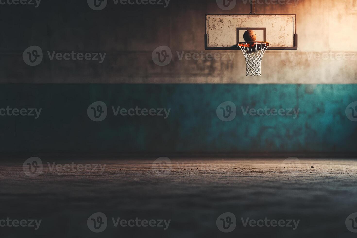 Empty basketball court at twilight with a single hoop. photo