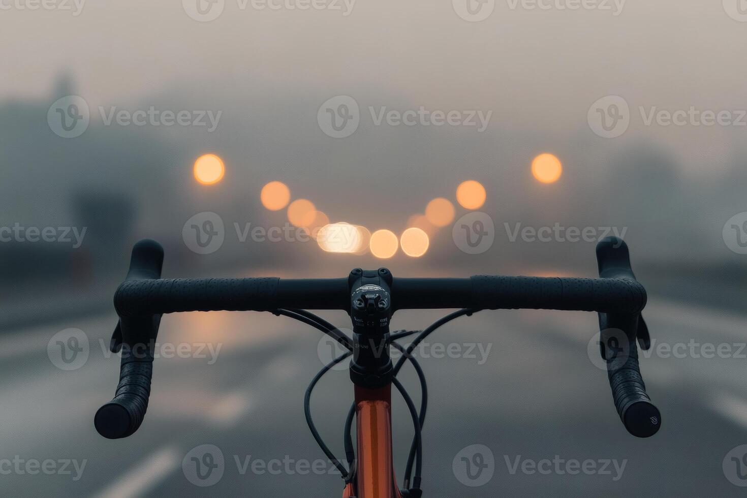 Riding into a misty dawn on a quiet empty road. photo