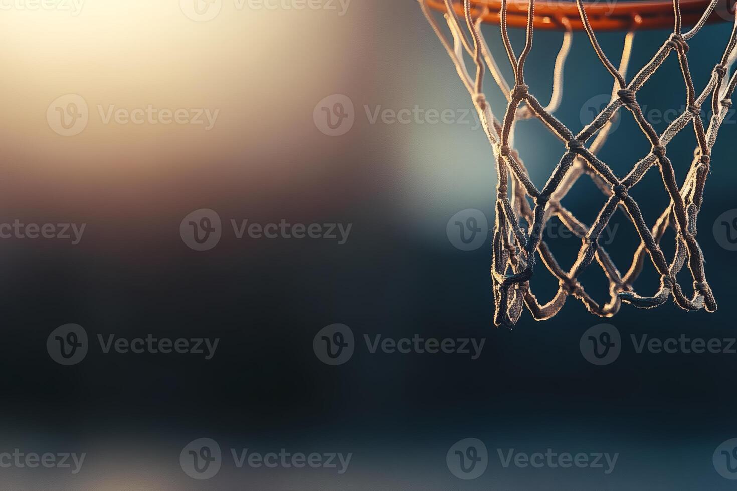 Basketball hoop hanging under soft sunset glow. photo
