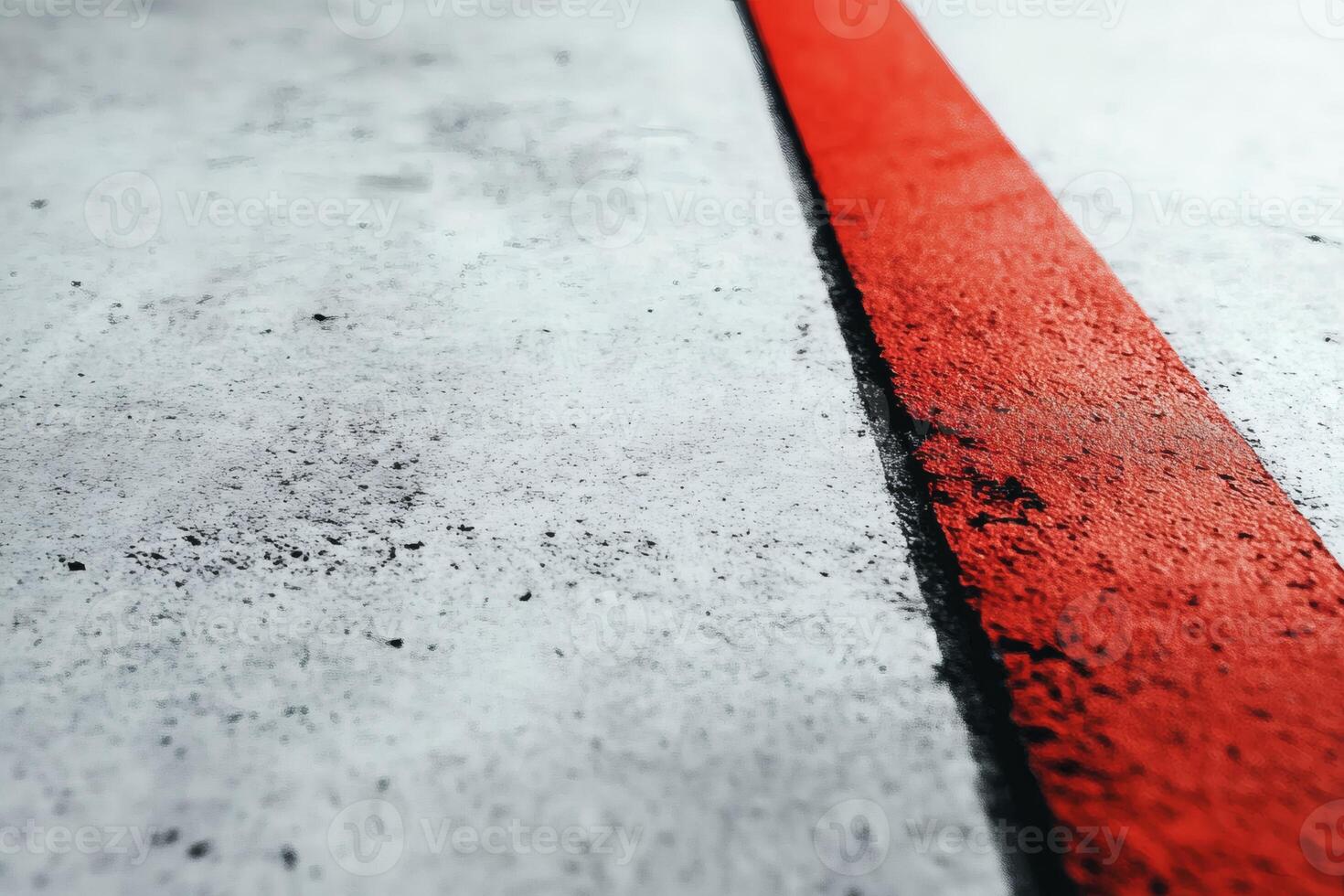 Vibrant red line on a textured concrete surface. photo