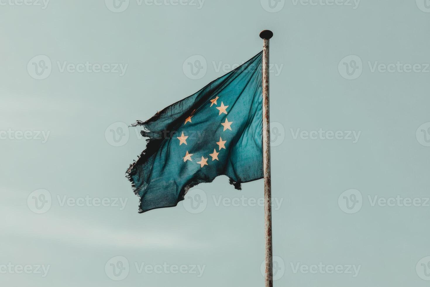 Worn flag of unity fluttering in the breeze. photo