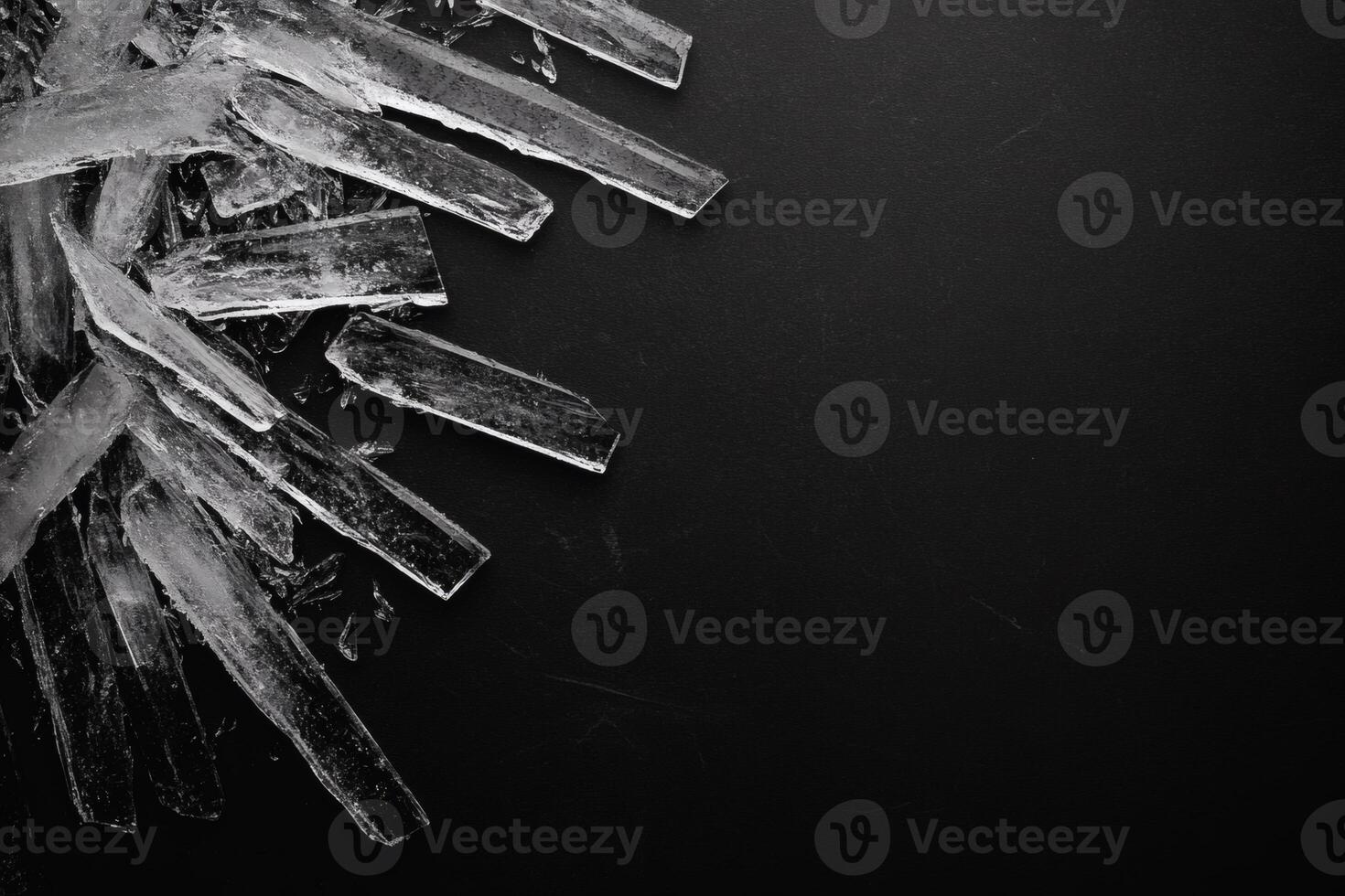 Ice formations creating a striking contrast on black surface. photo
