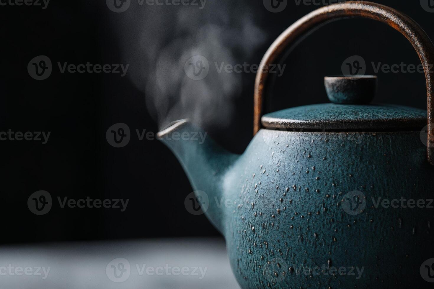Steam rises from a beautifully crafted teapot. photo