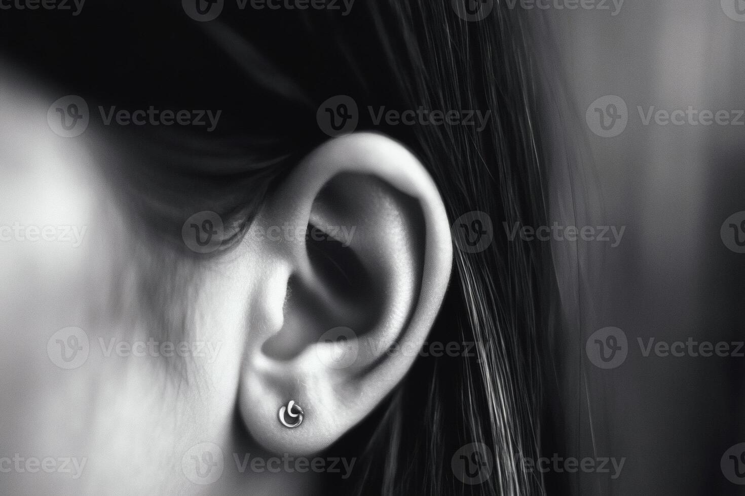 Intricate earring shines against a soft background. photo