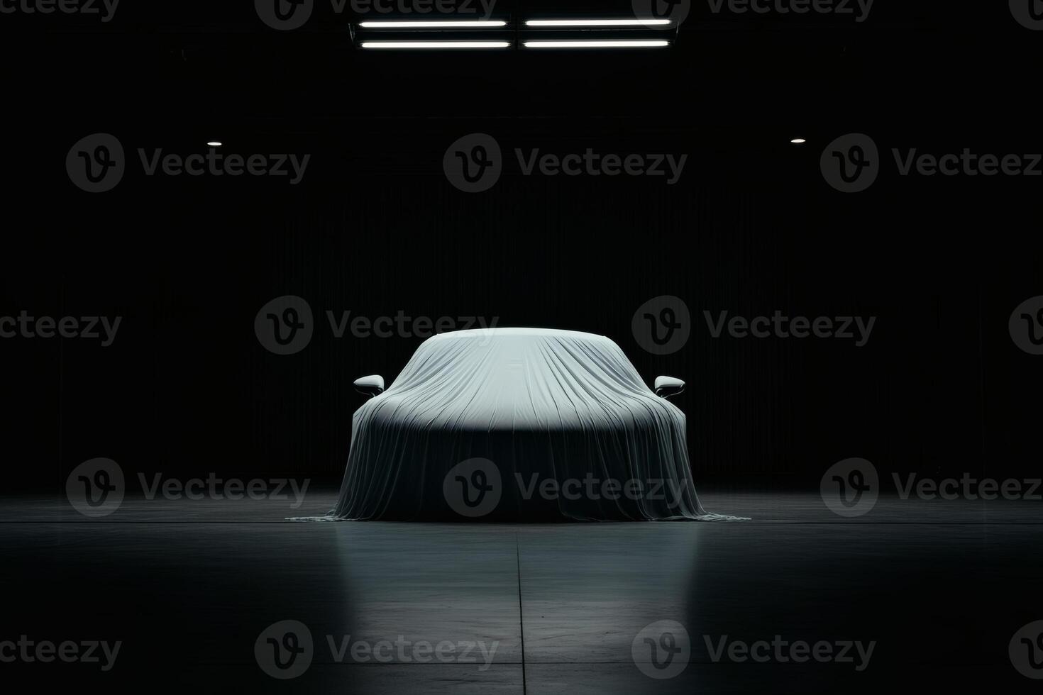 Unveiling the mystery of a covered luxury car at night. photo