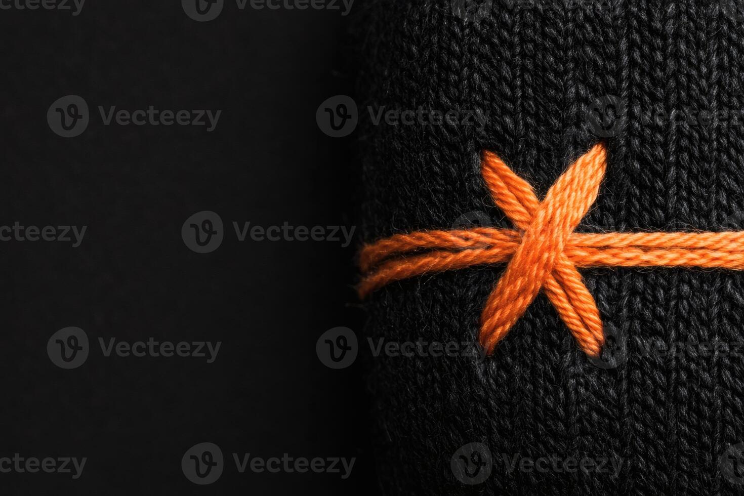 Intricate stitching details on a dark fabric texture. photo