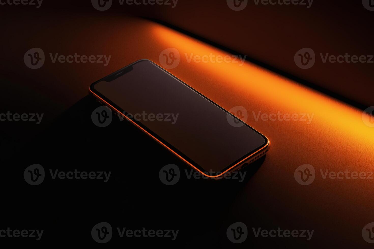 Modern smartphone illuminated by warm orange light on a sleek surface. photo