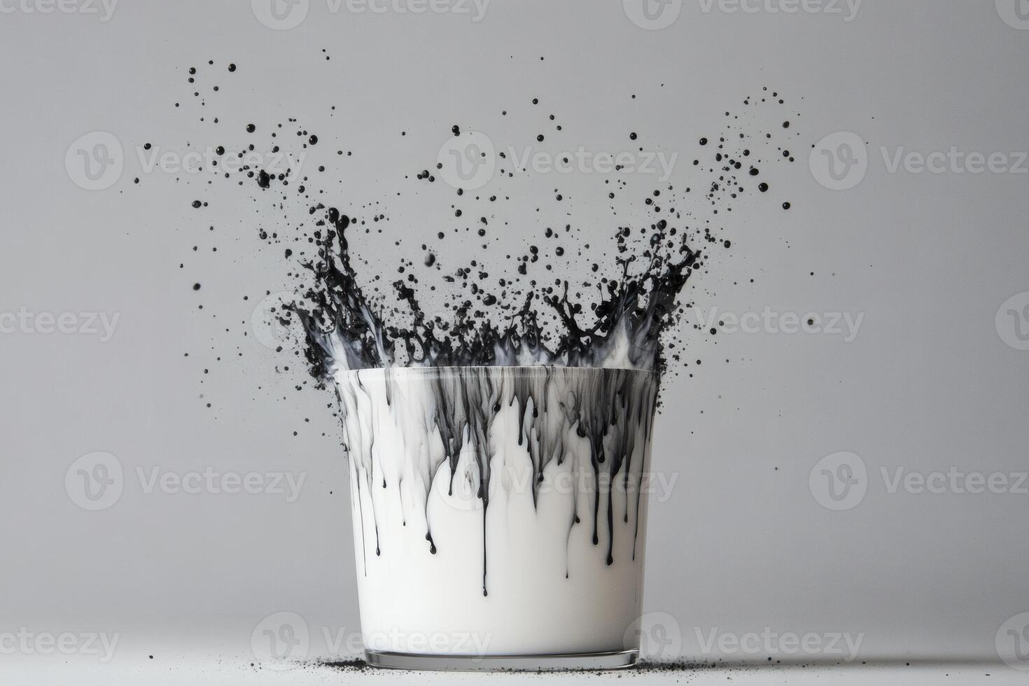 Creative splash of black paint merging with white liquid in artistic display. photo