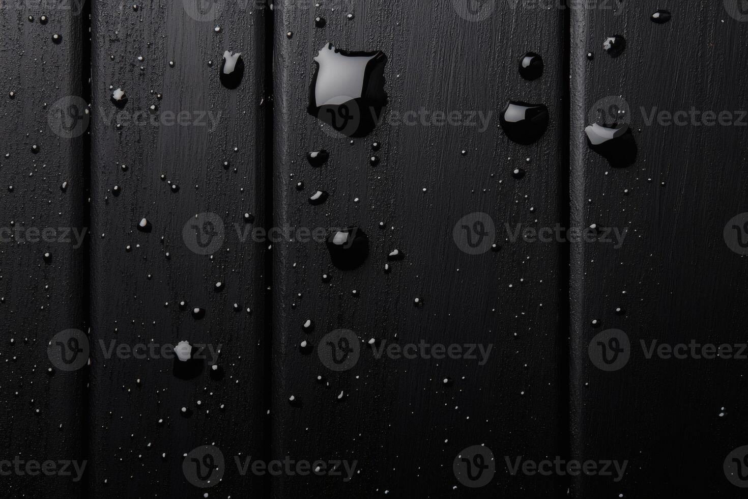Shimmering droplets on dark surface create a mesmerizing contrast of light and shadow. photo