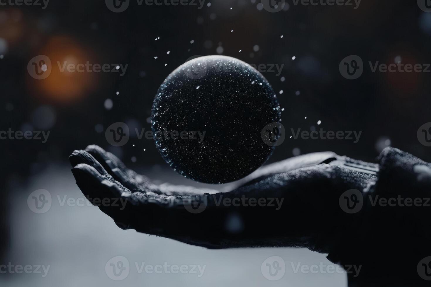 Mystical orb floating gently above a gloved hand in a winter wonderland. photo