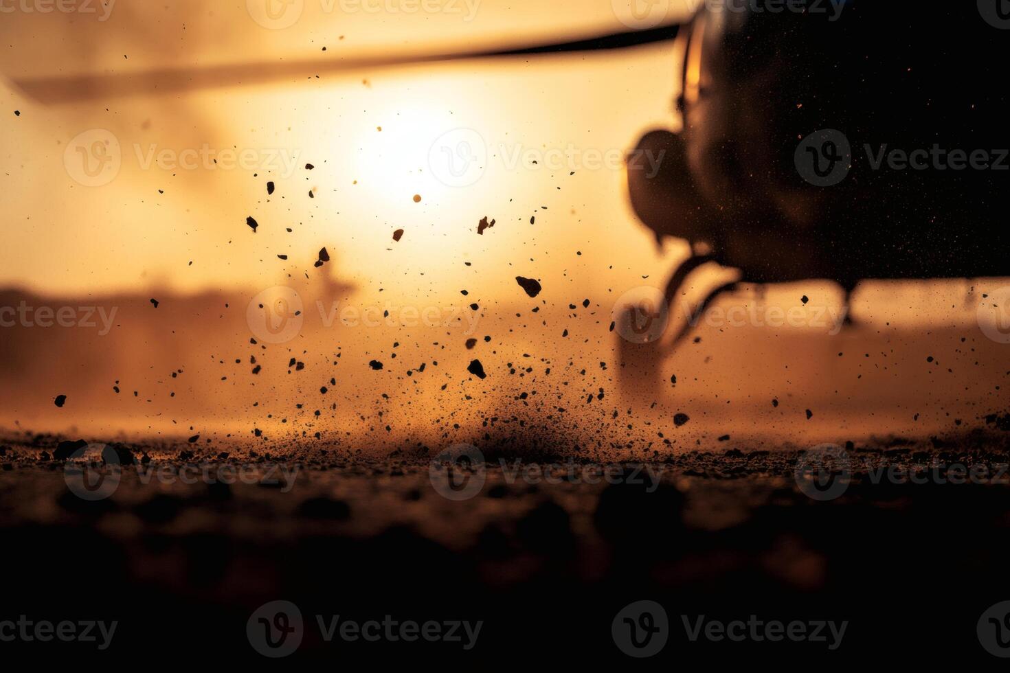 Helicopter Dust Clouds Rise as the Sun Sets in a Dynamic Landscape. photo