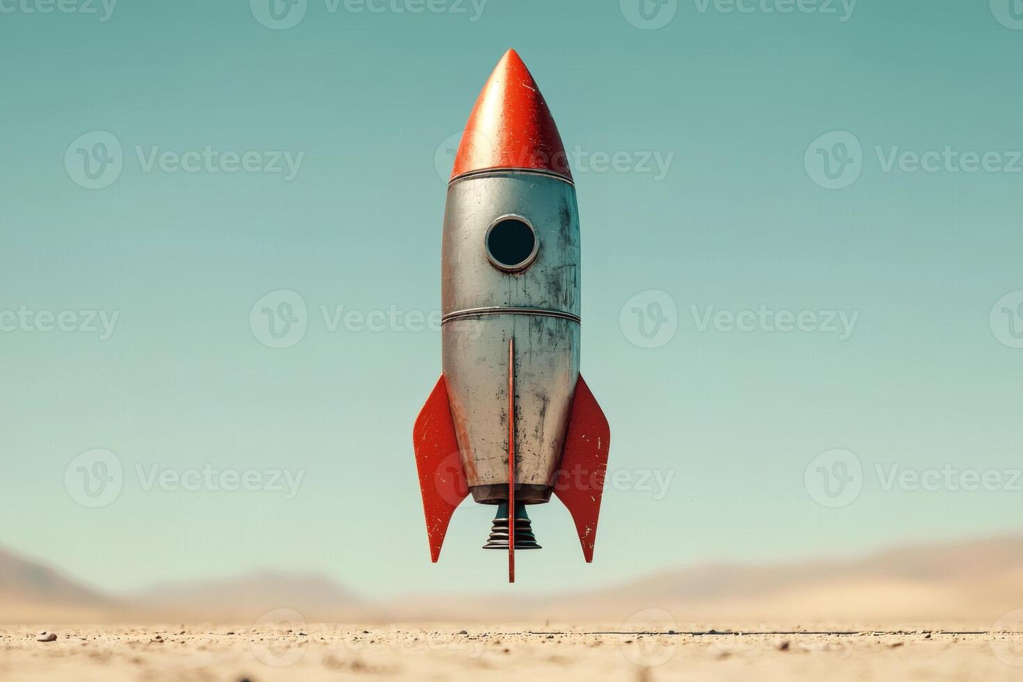 Rocket poised for launch in a vast desert photo