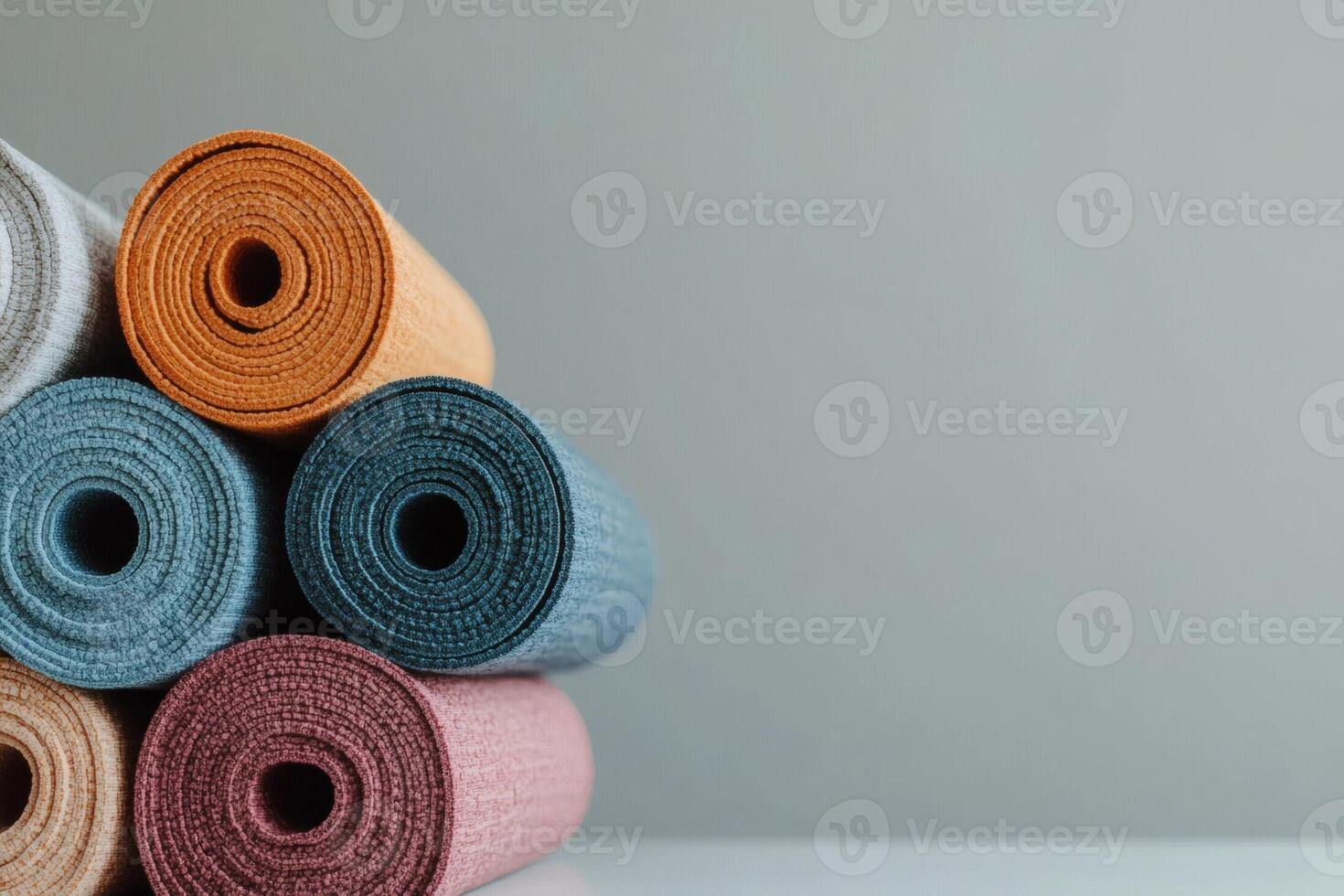 Colorful yoga mats neatly stacked for practice photo