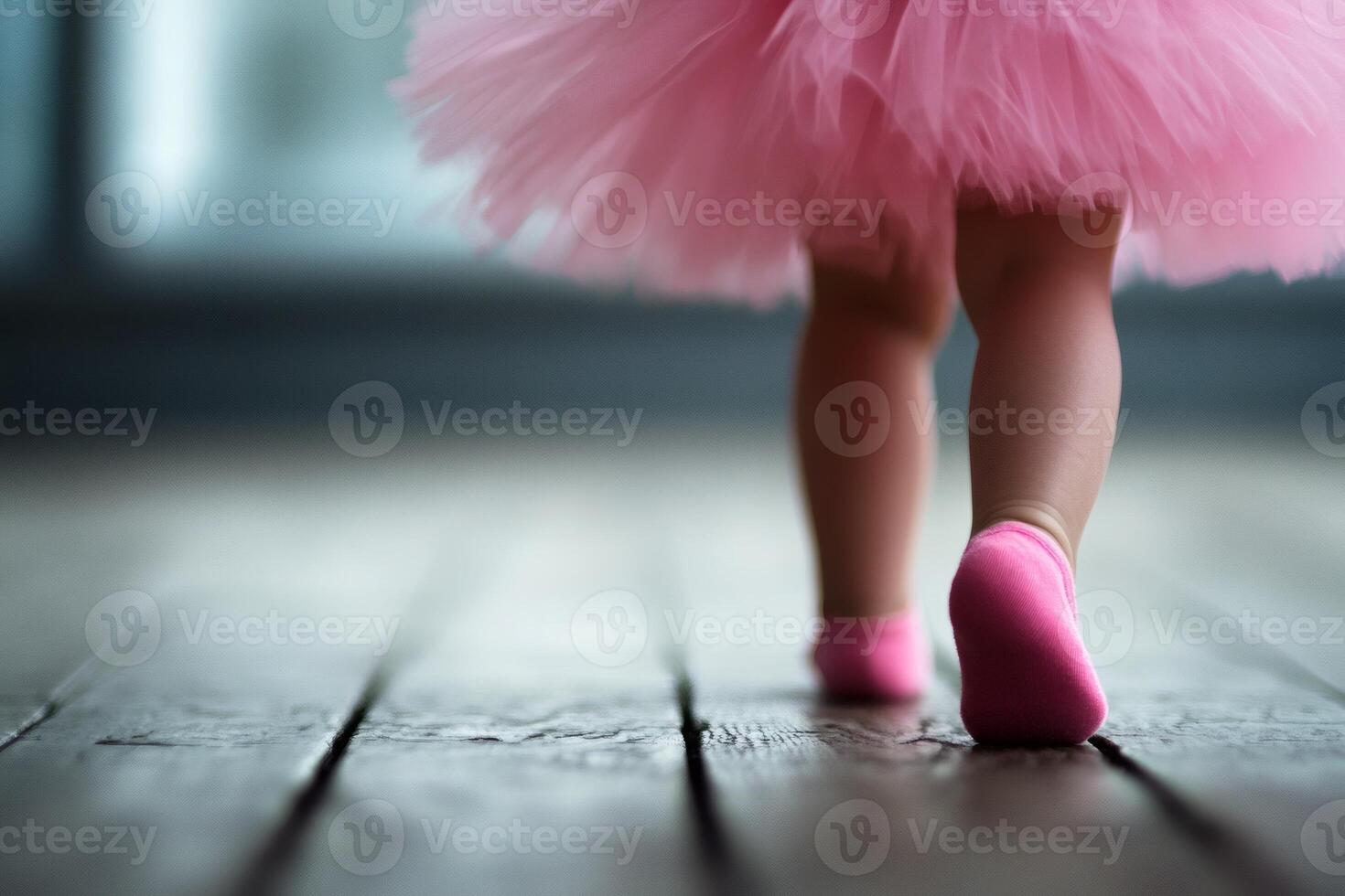 Little feet in a pink tutu take graceful steps photo
