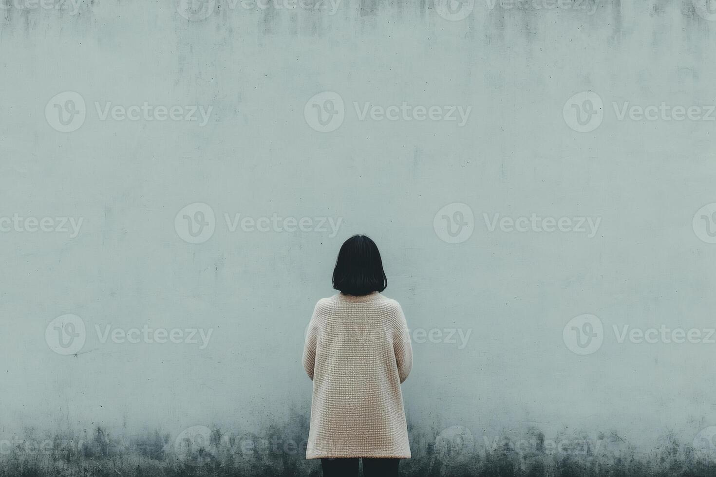 Contemplative solitude against a blank wall photo