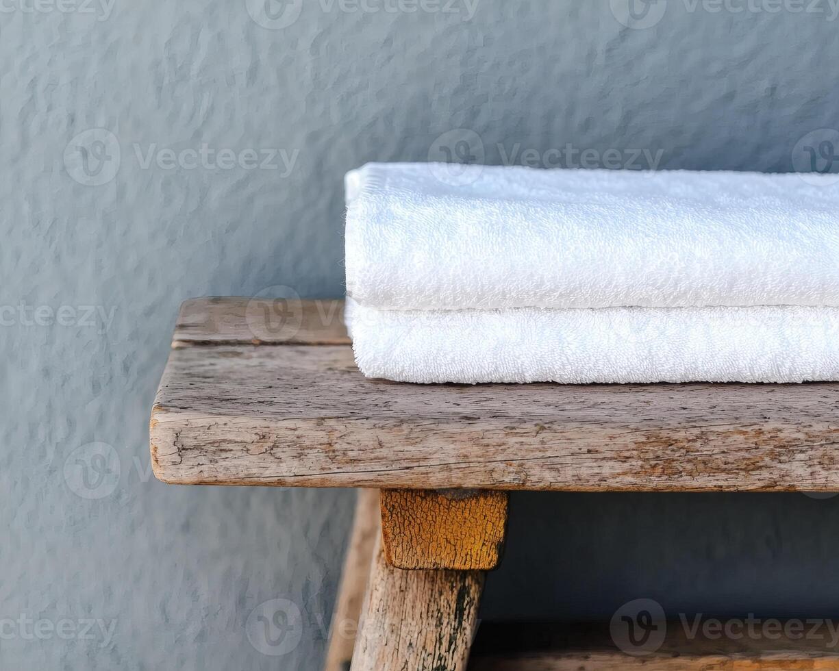 Soft towels resting on a rustic wooden shelf photo