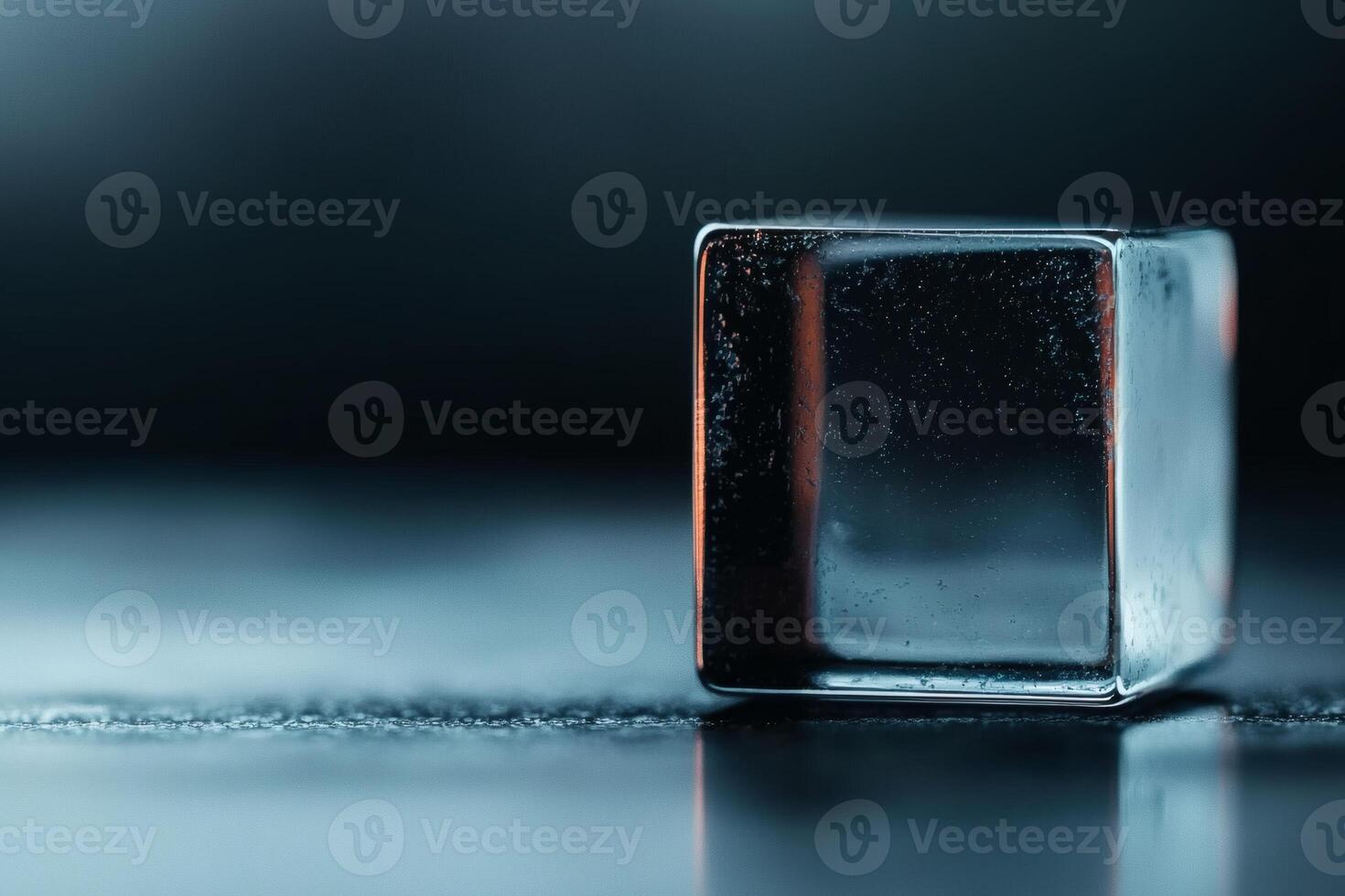 Crystal clear ice cube glistening in light photo