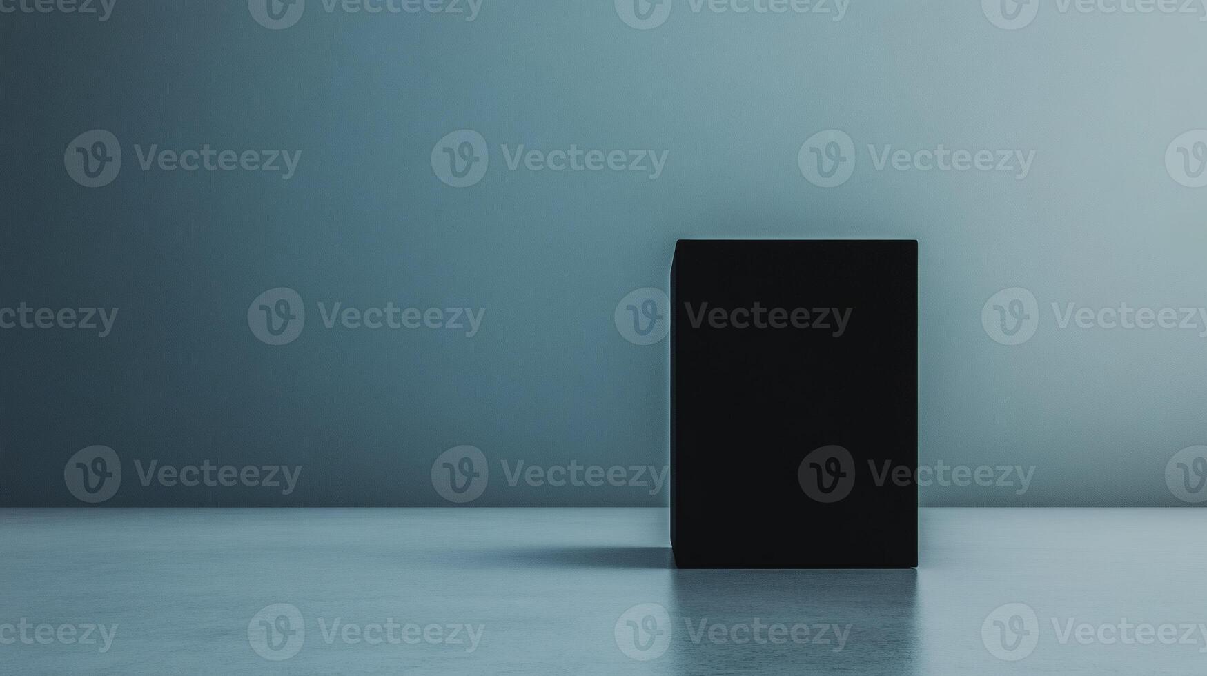 Mysterious black cube standing alone in a minimalist space with soft lighting during twilight hours photo