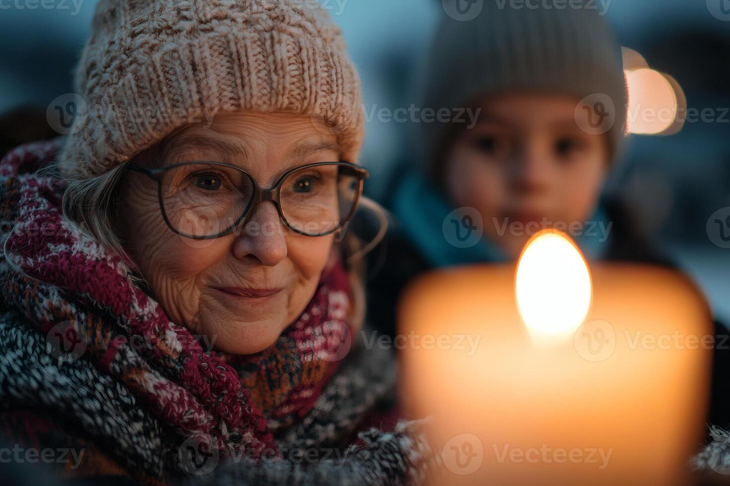Connection and warmth shared by a grandmother and grandchild during evening candlelight gathering in winter photo