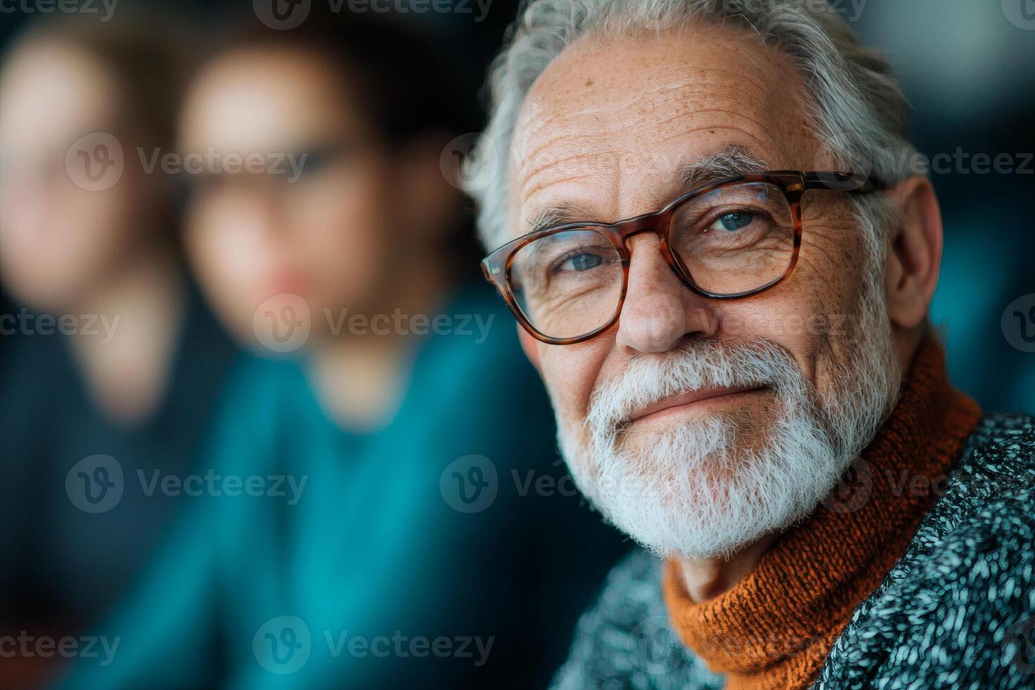Elderly man with glasses and a warm smile engaged in deep conversation at a cozy indoor gathering during the late afternoon photo
